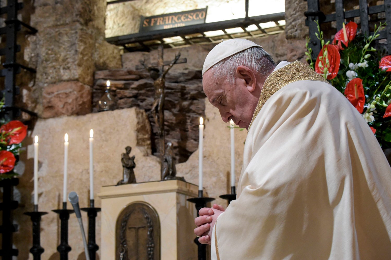 Pope Francis celebrates Mass at the tomb of St. Francis in the crypt of the Basilica of St. Francis in Assisi, Italy, Oct. 3, 2020. The pope signed his new encyclical, "Fratelli Tutti, on Fraternity and Social Friendship," at the end of the Mass.